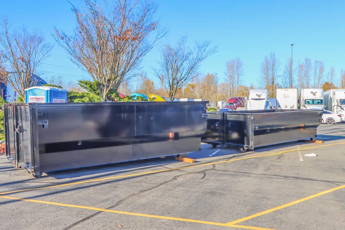 Professional dumpster rental service with roll-off container on residential driveway in Princeton